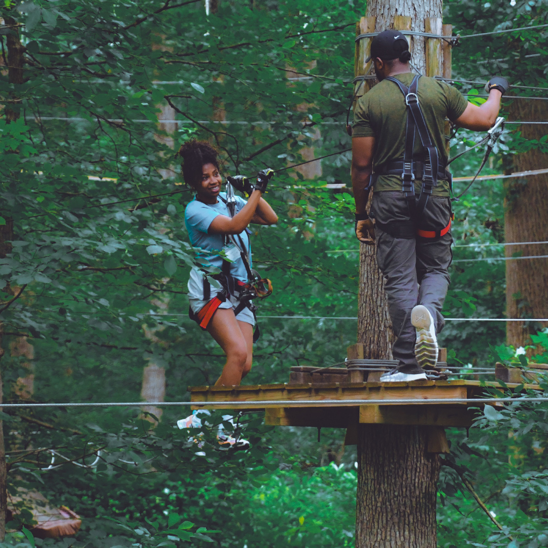 couple climbing in the trees